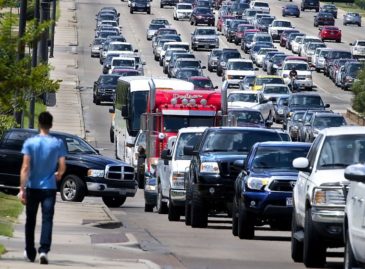 rows of vehicles sitting in traffic on a multi-lane road