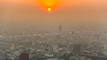 smog over a city at sunset