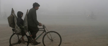 A man and his child ride on a bicycle in heavy smog in Lahore, Pakistan Image: REUTERS/Mohsin Raza
