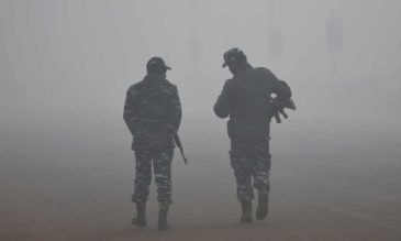 Photo of Indian security forces in heavy smog in Delhi. Photograph: Money Sharma/AFP/Getty Images