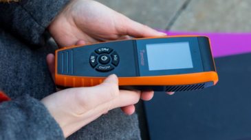 Image: Natalie Ward, a senior at Fordham University, uses a Temtop air quality device to monitor levels of particulate matter, or PM2.5, in the Fordham and University Heights neighborhoods of the Bronx. Photo Credit: Marisol Diaz-Gordon